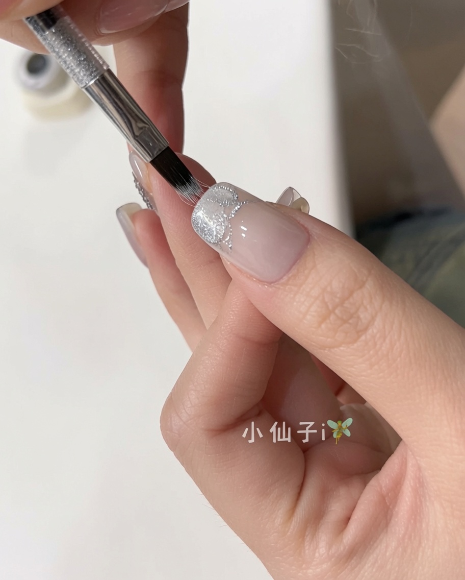 기본 정리된 손톱 위에 은빛 캣아이 젤을 바르는 모습.