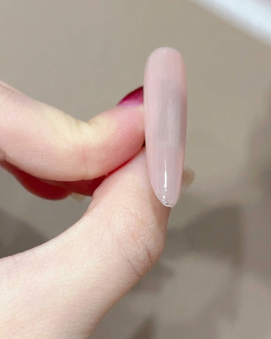 보풀 없는 솜으로 큐어링된 젤 네일 표면을 닦는 모습.