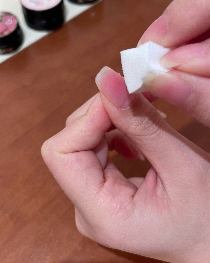 메이크업 스펀지를 사용하여 피치색 젤을 톡톡 두드리며 손톱 표면에 부드러운 그라데이션을 연출하는 모습.