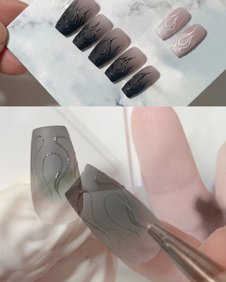 매트한 회색 네일 위 중앙 불꽃의 뾰족한 끝부분을 라이너 브러시로 세밀하게 다듬는 모습.