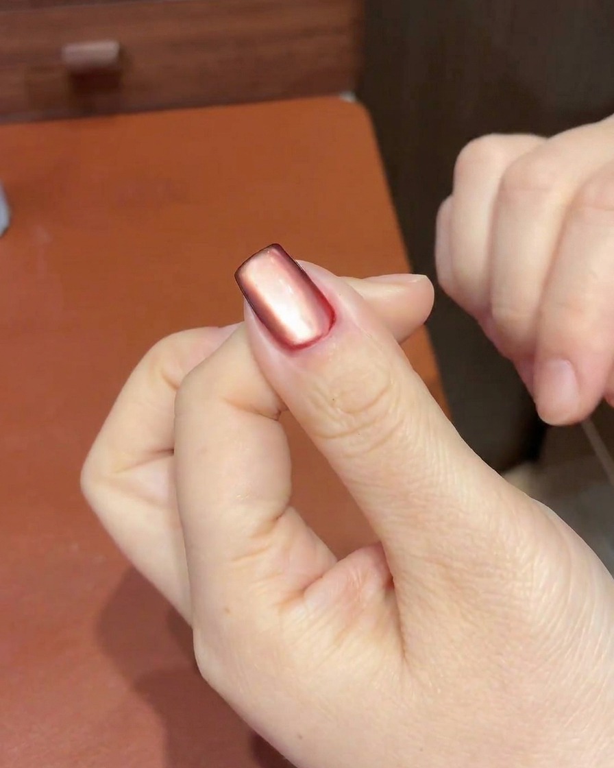 자석을 사용하여 중앙의 펄을 큐티클 쪽으로 당겨 하이라이트를 만드는 모습.
