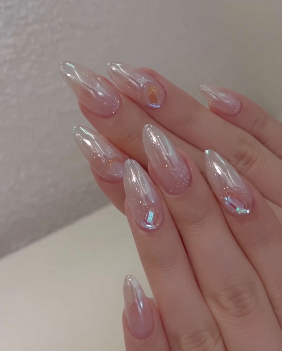 보라색 큐어링 빛이 켜진 전문가용 UV/LED 젤 램프 안에 손을 넣고 물방울 네일을 경화시키는 클로즈업 모습.