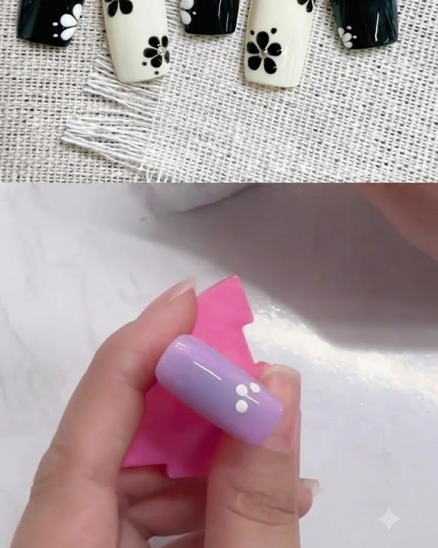 부분적인 원 모양으로 네 개의 화이트 도트가 배열된 보라색 네일의 클로즈업.