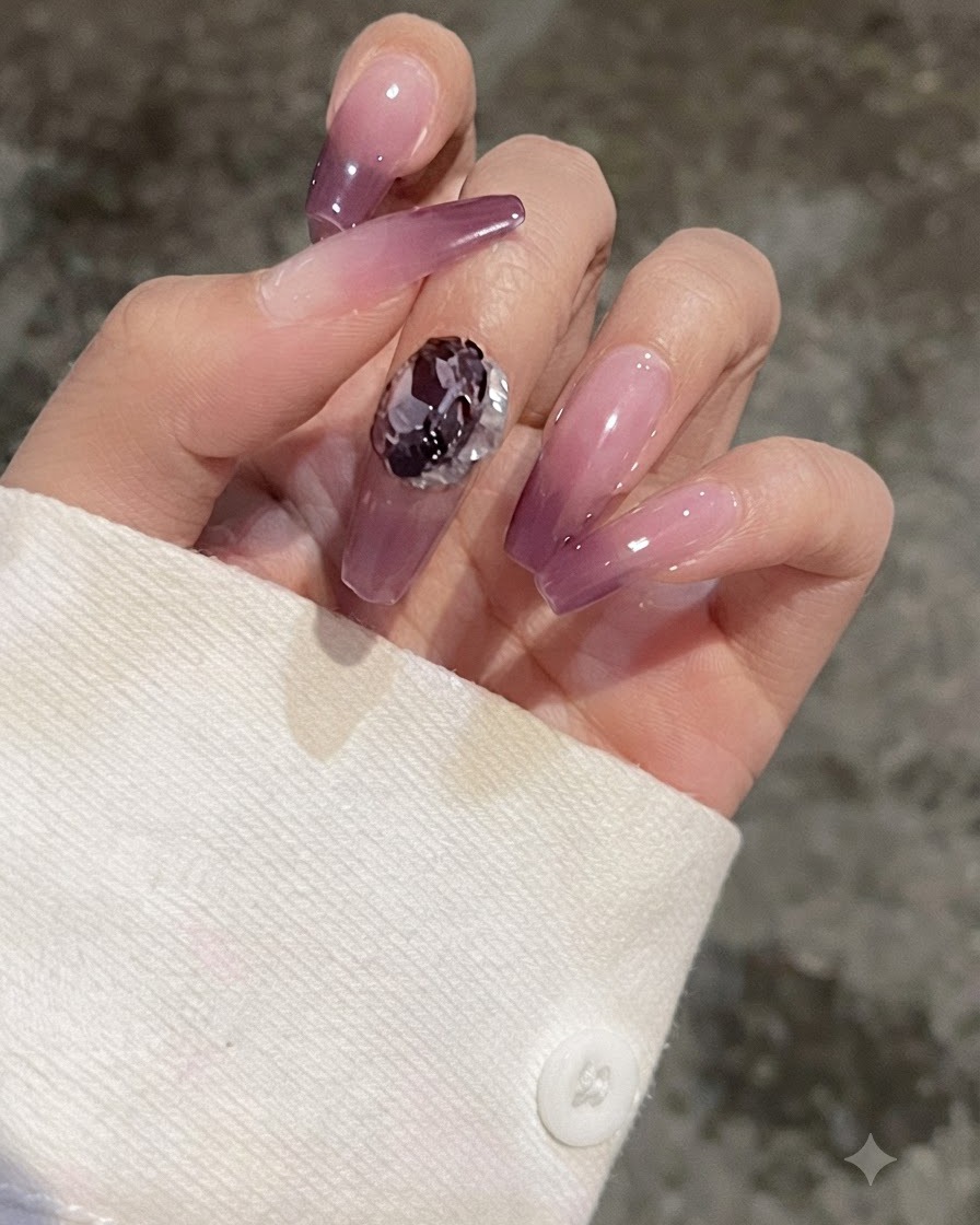 퍼플 그라데이션 네일 위에 하트 모양 젬을 올려 비교해 보는 손가락 클로즈업.